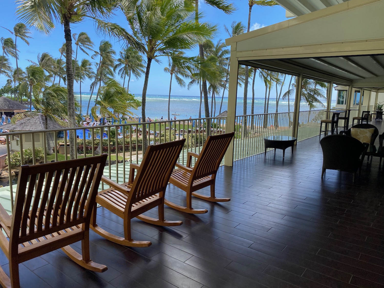 a deck with chairs and a view of the ocean