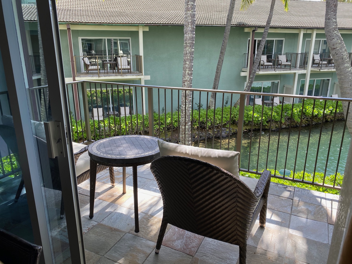 a chair and table on a balcony