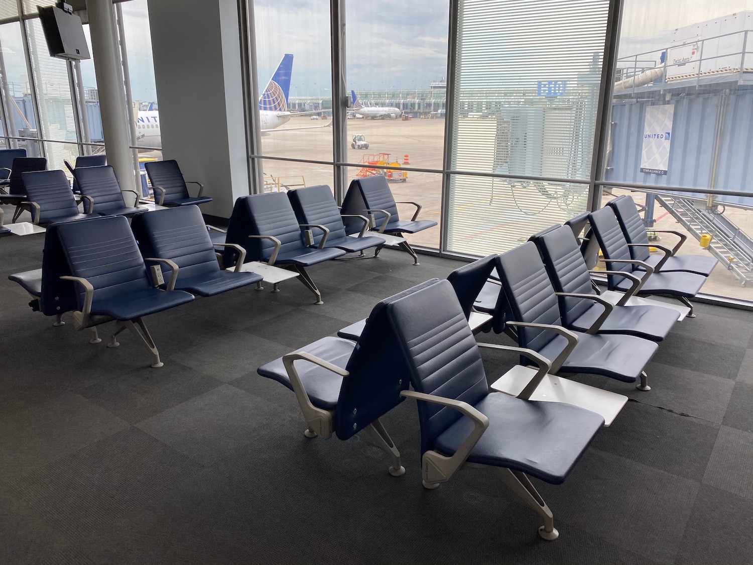 a row of chairs in a room with windows