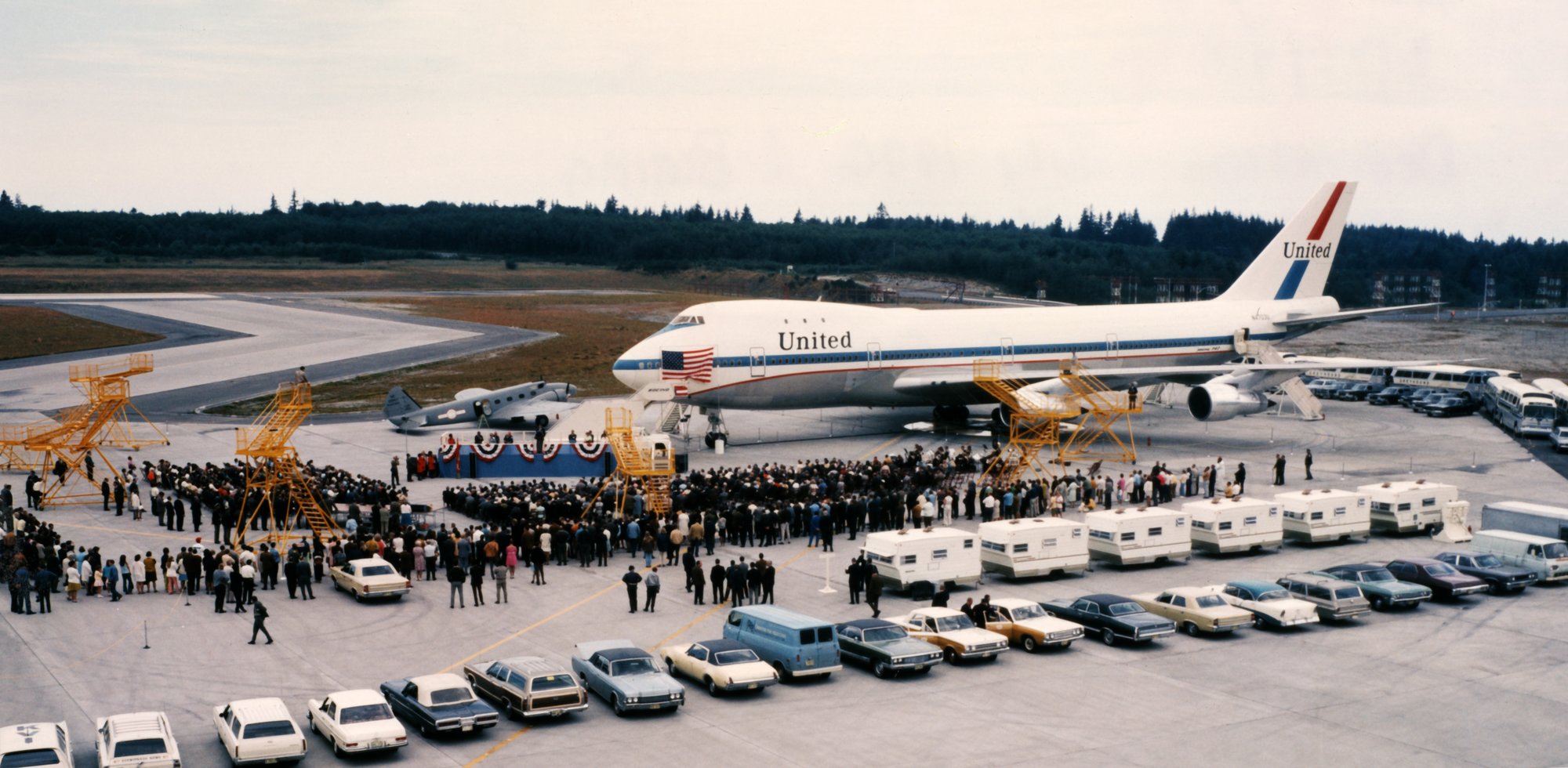 a group of people standing around an airplane