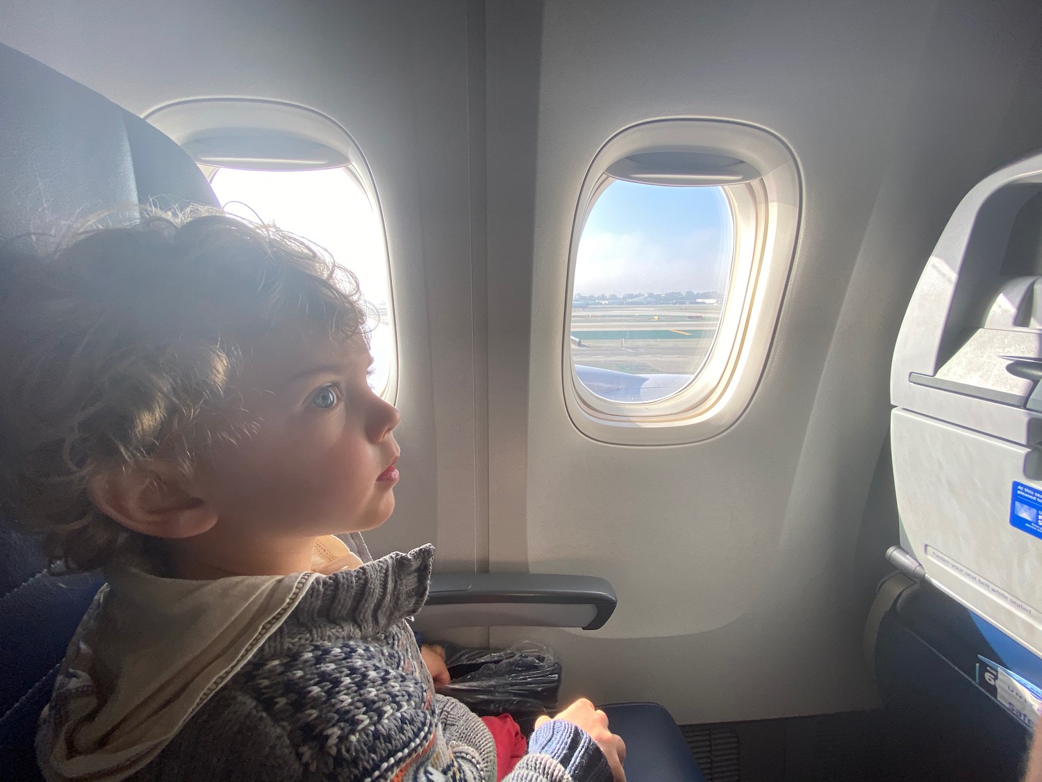 a child looking out of an airplane window