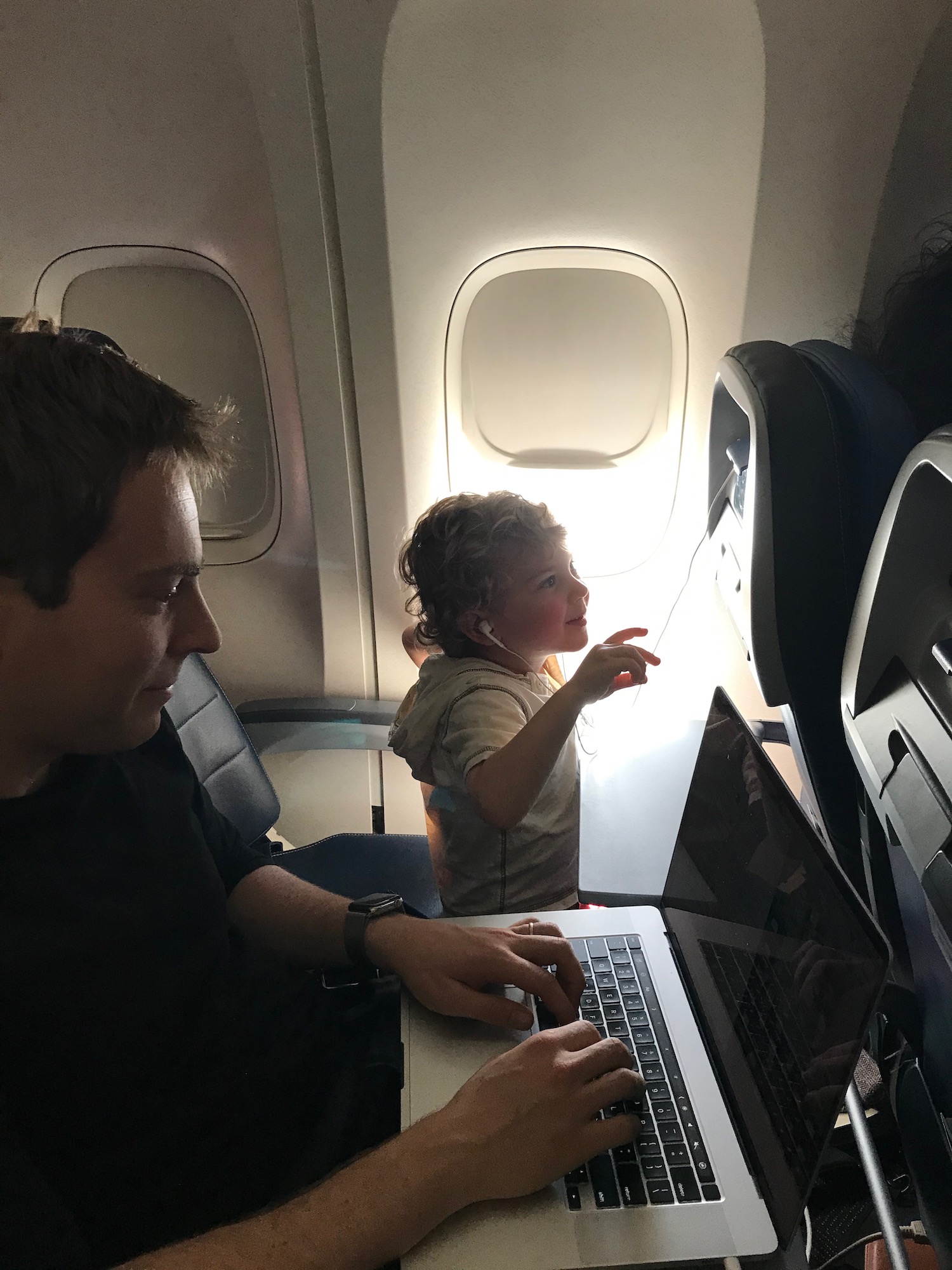 a man and child on an airplane