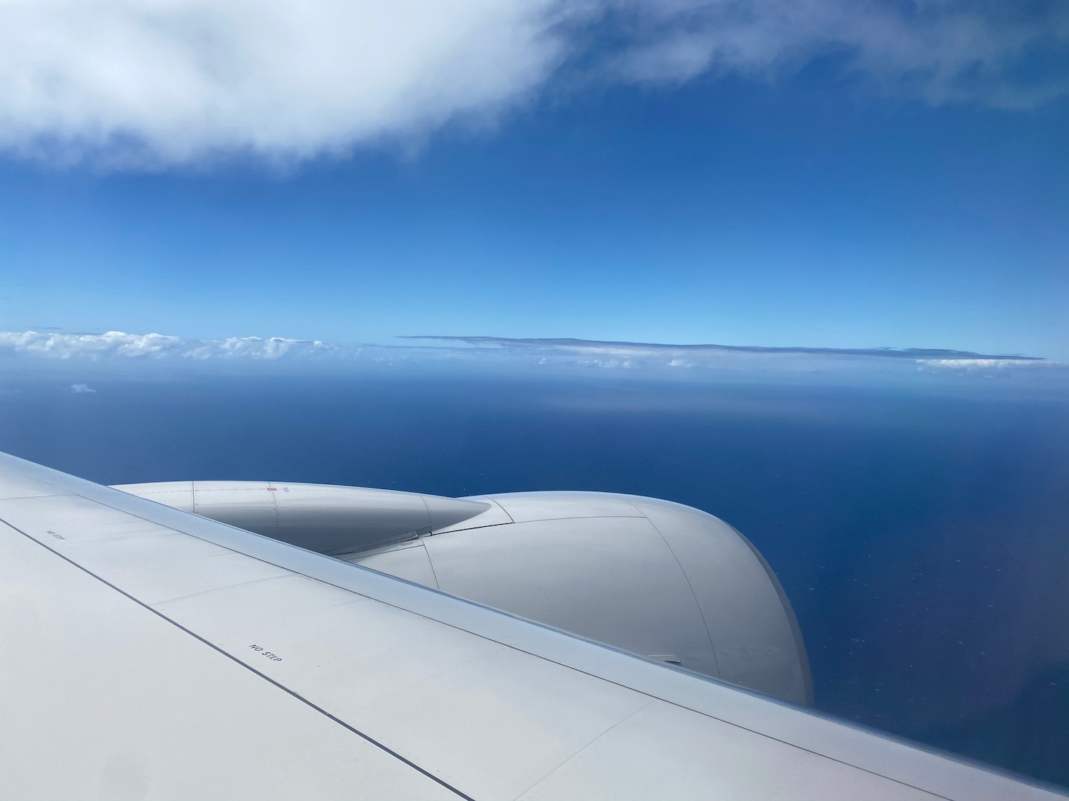 an airplane wing and blue sky