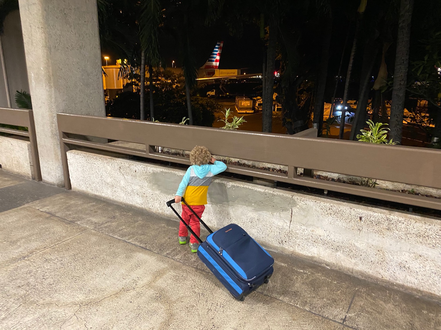 a child with a suitcase on a bench