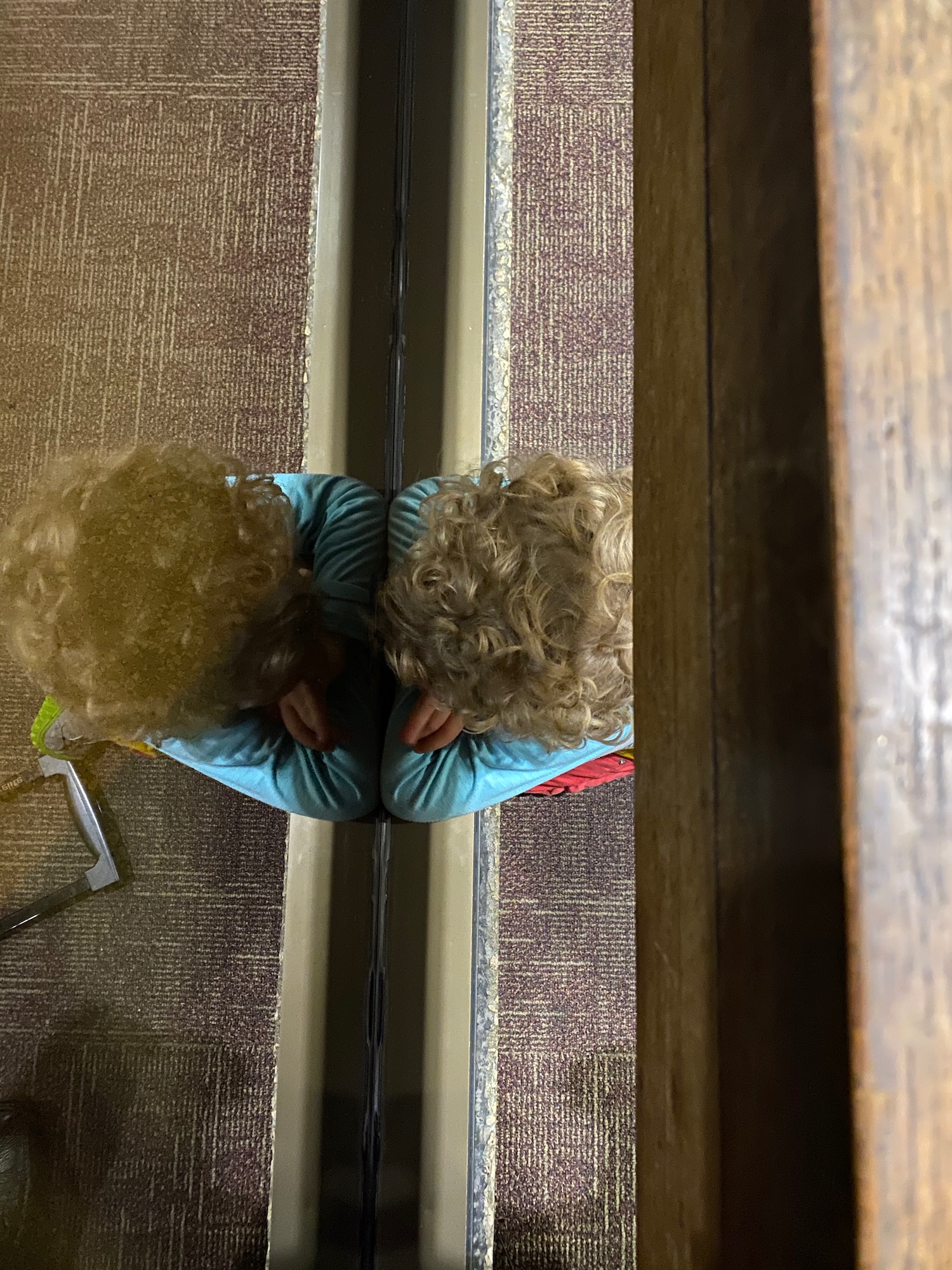 a child leaning on a mirror