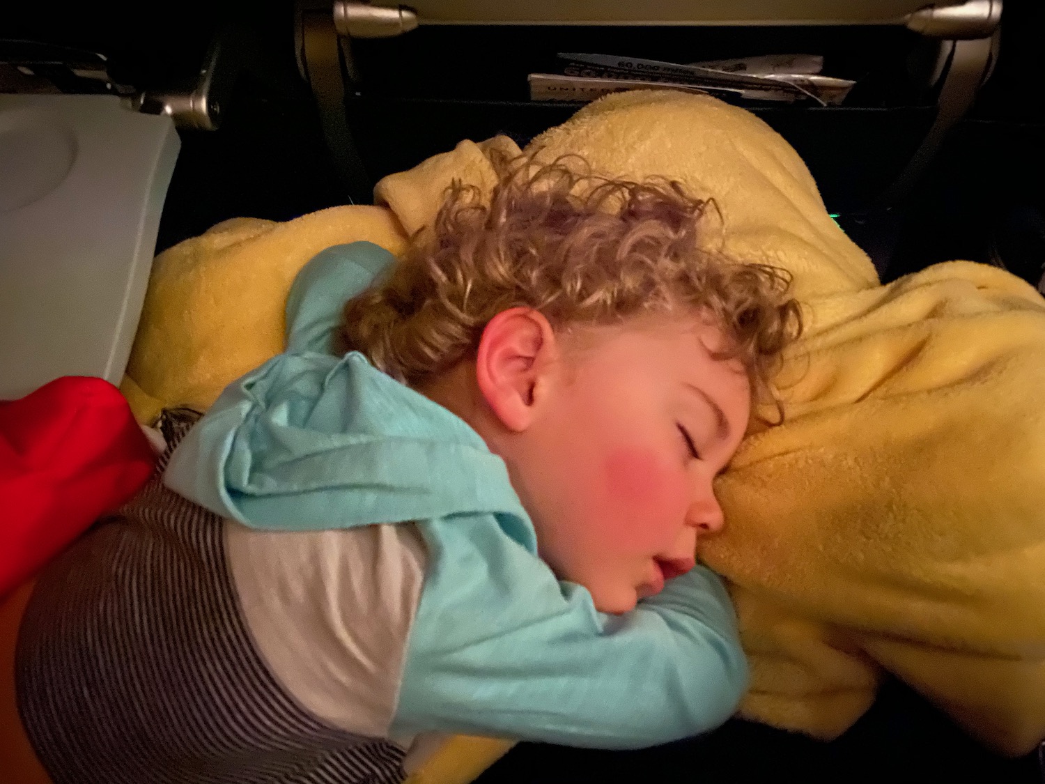 a child sleeping on a yellow blanket