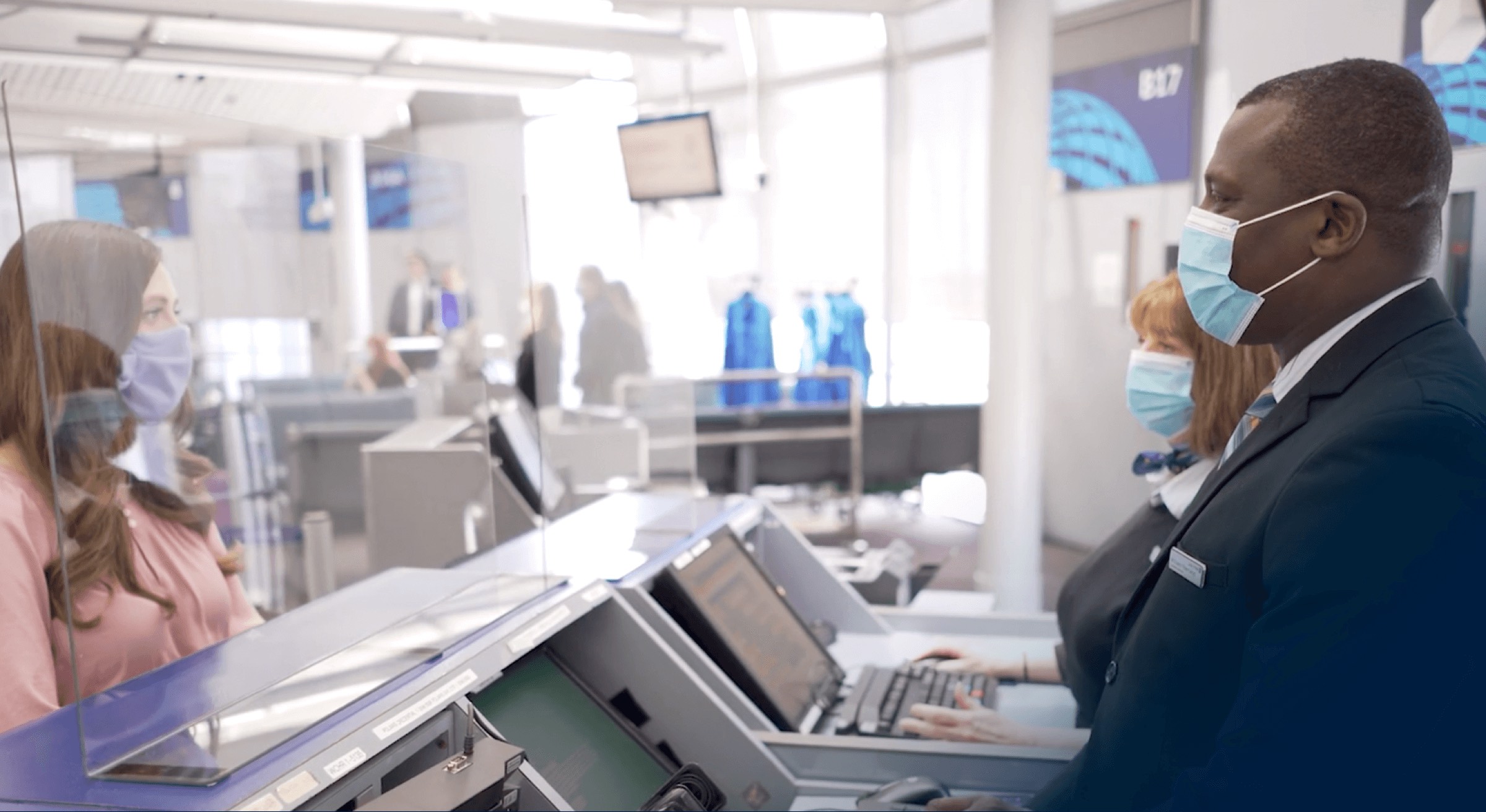 a woman wearing a mask and using a computer