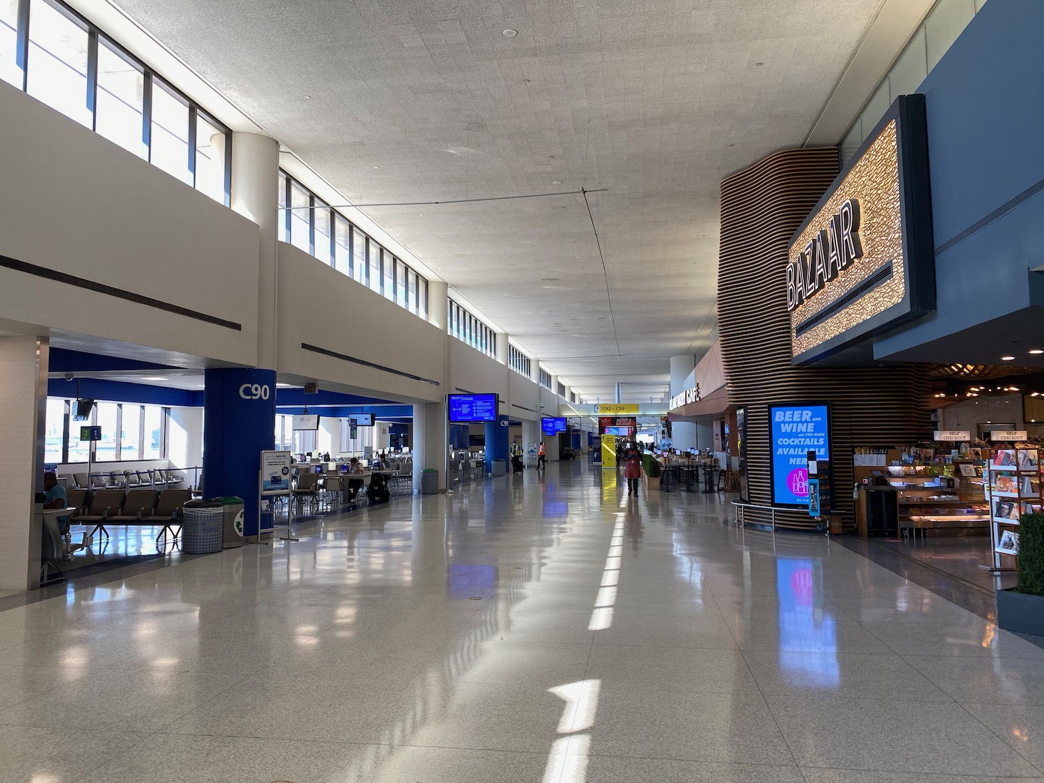 a large airport terminal with people walking