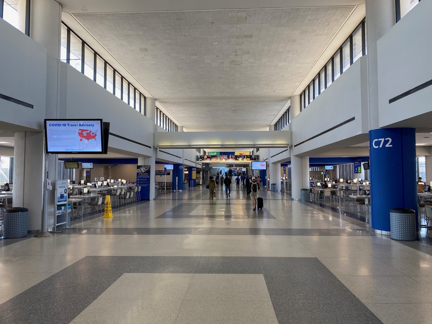 people walking in a large airport terminal