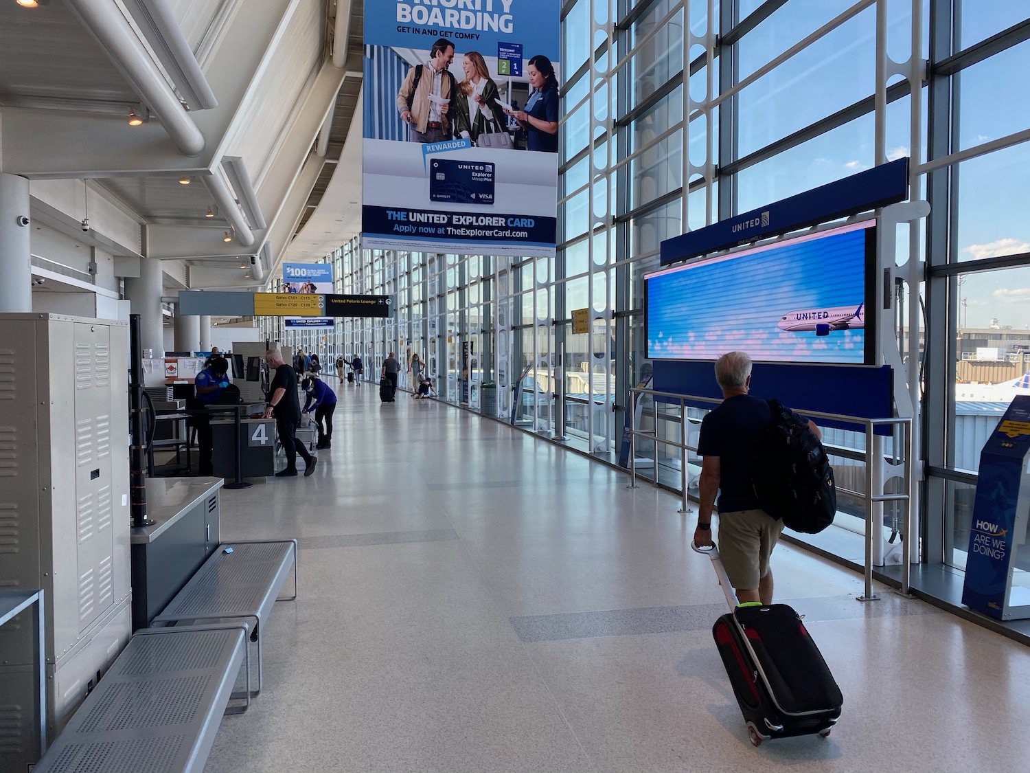 a man pulling a suitcase in an airport terminal