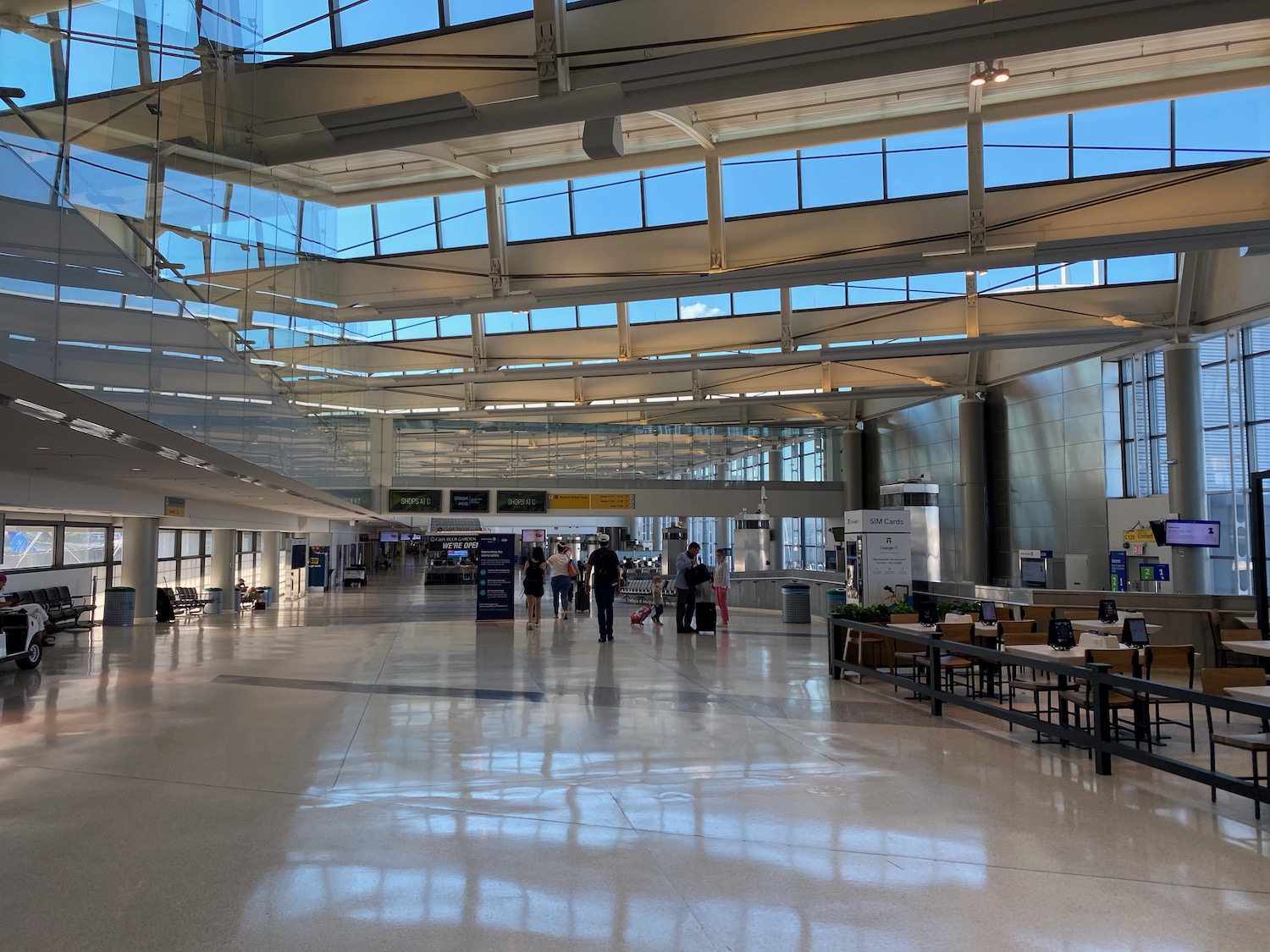 people walking in a large airport terminal