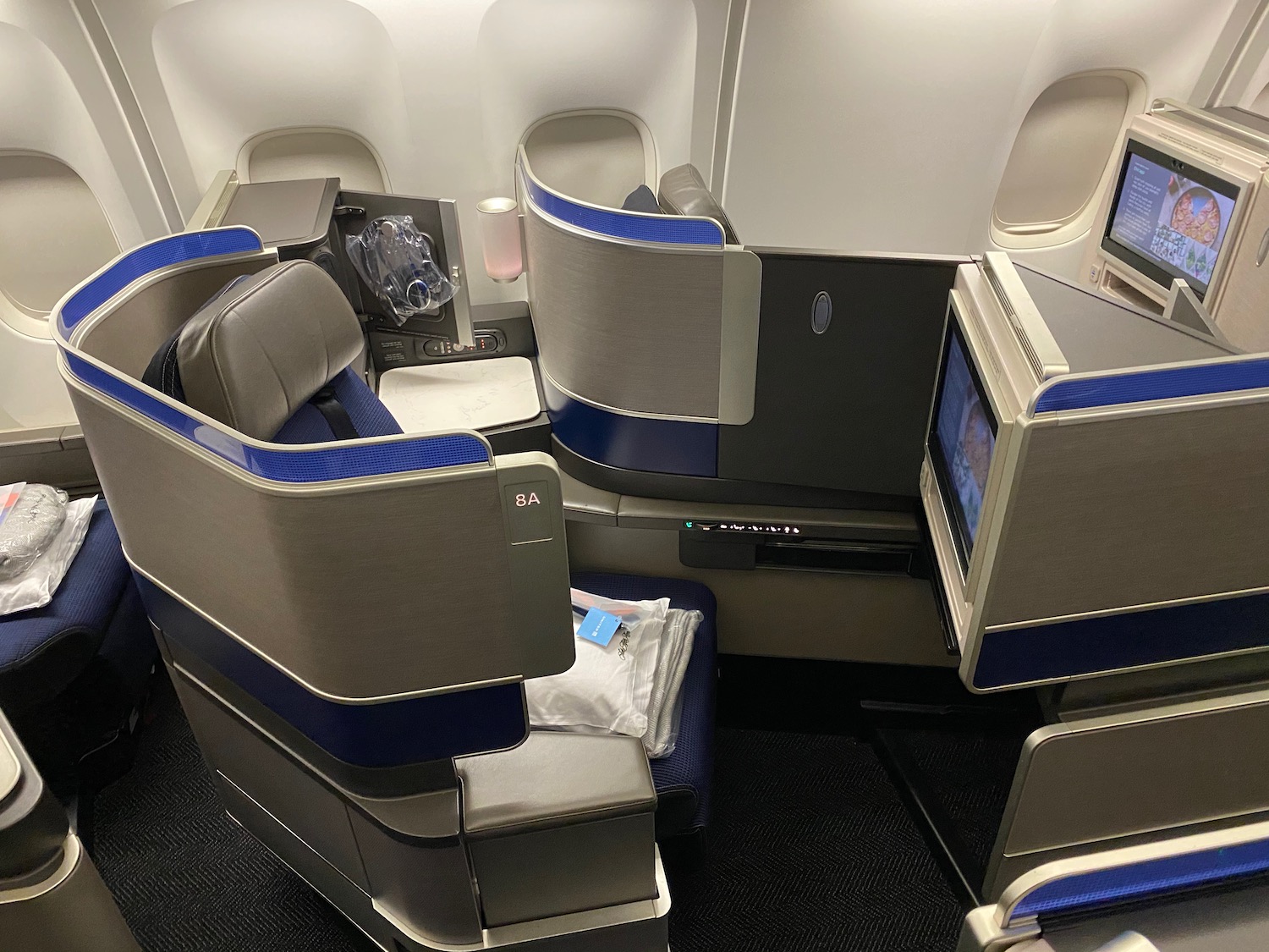 a seat and a monitor in an airplane