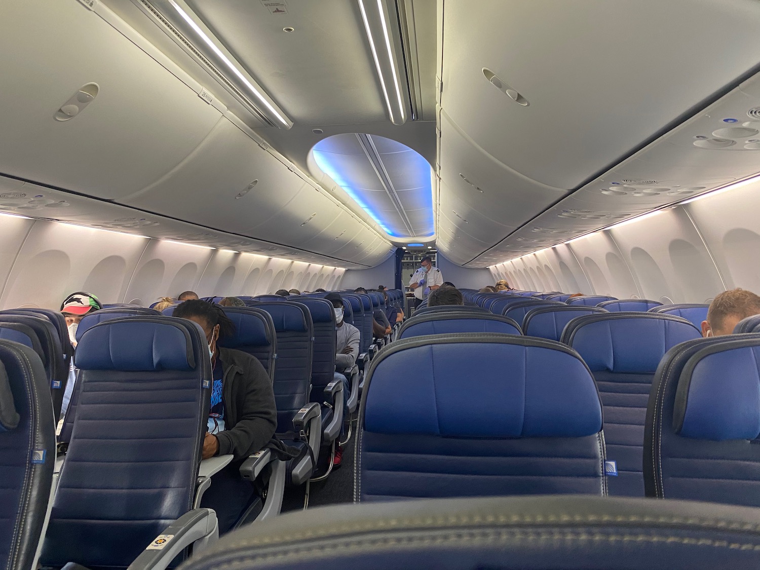 inside an airplane with people sitting on seats