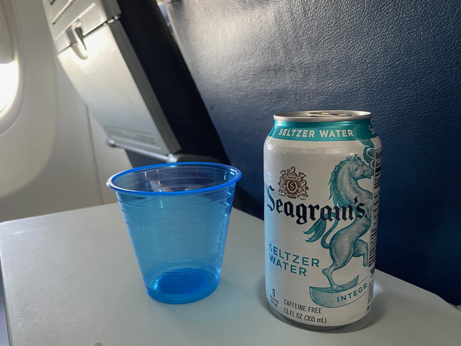 a can of beer and a plastic cup