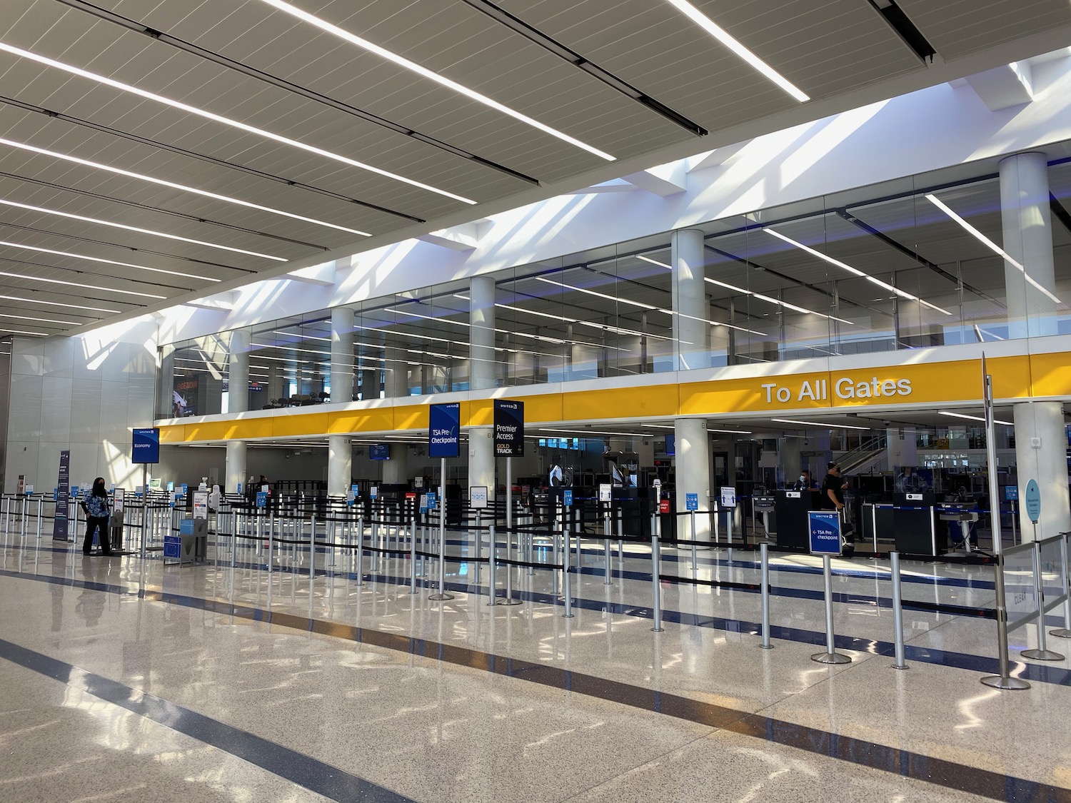 a large airport terminal with people walking around