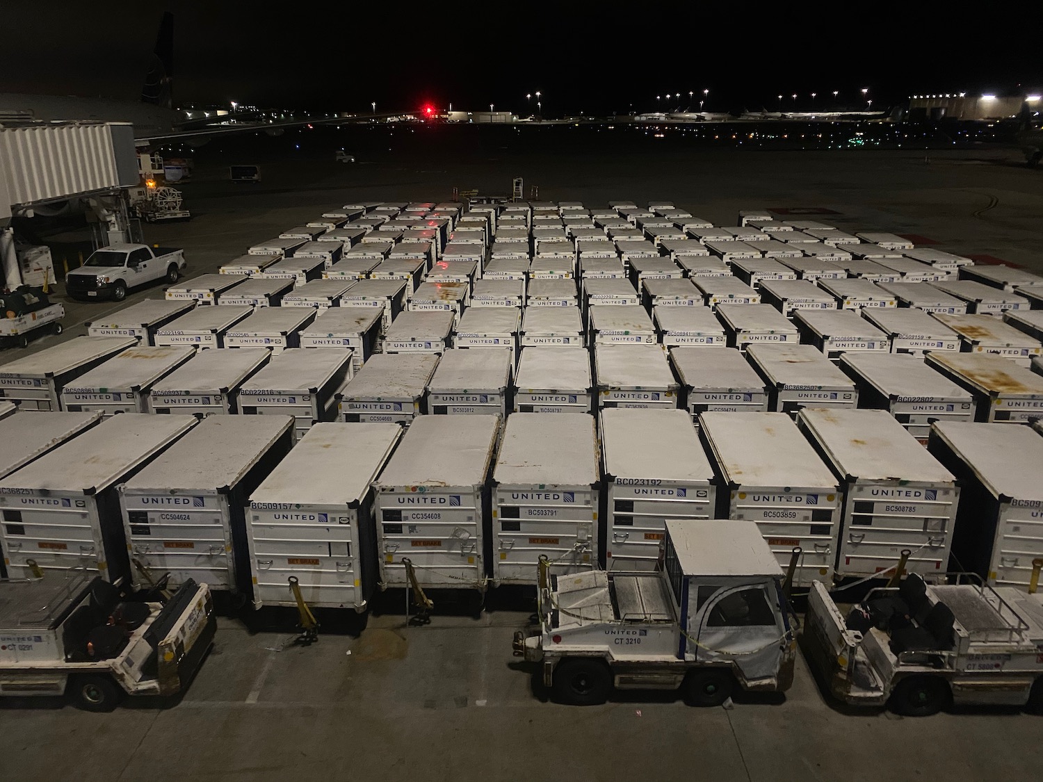 a group of white containers on a tarmac
