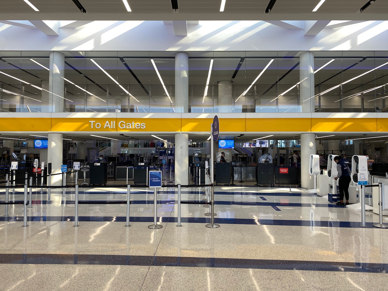 a large airport terminal with a yellow sign