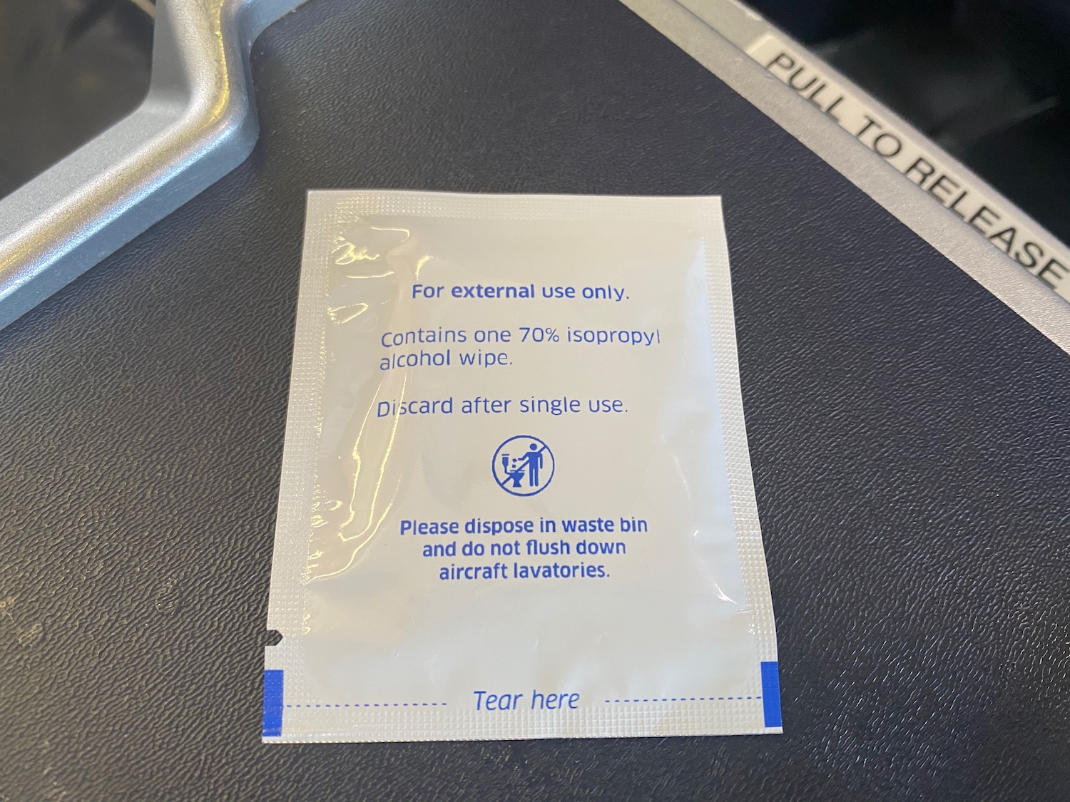 a white packet with blue text on a black surface