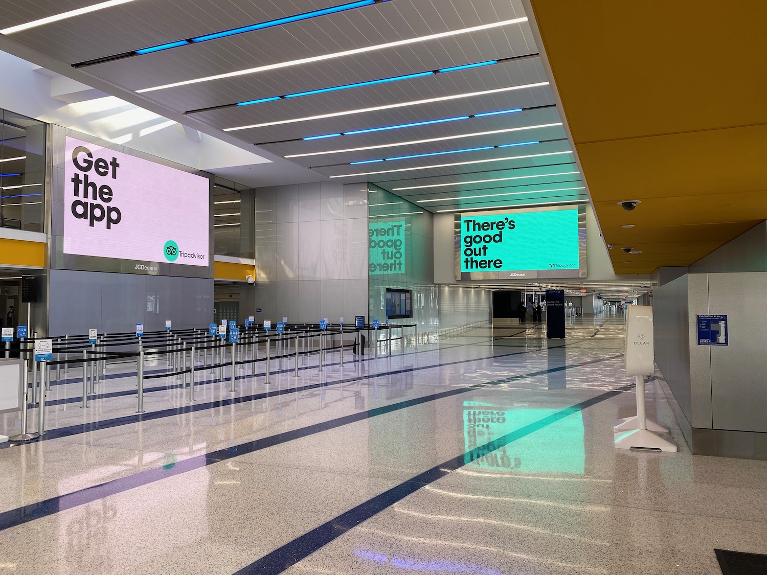 a large hall with signs and luggage carts