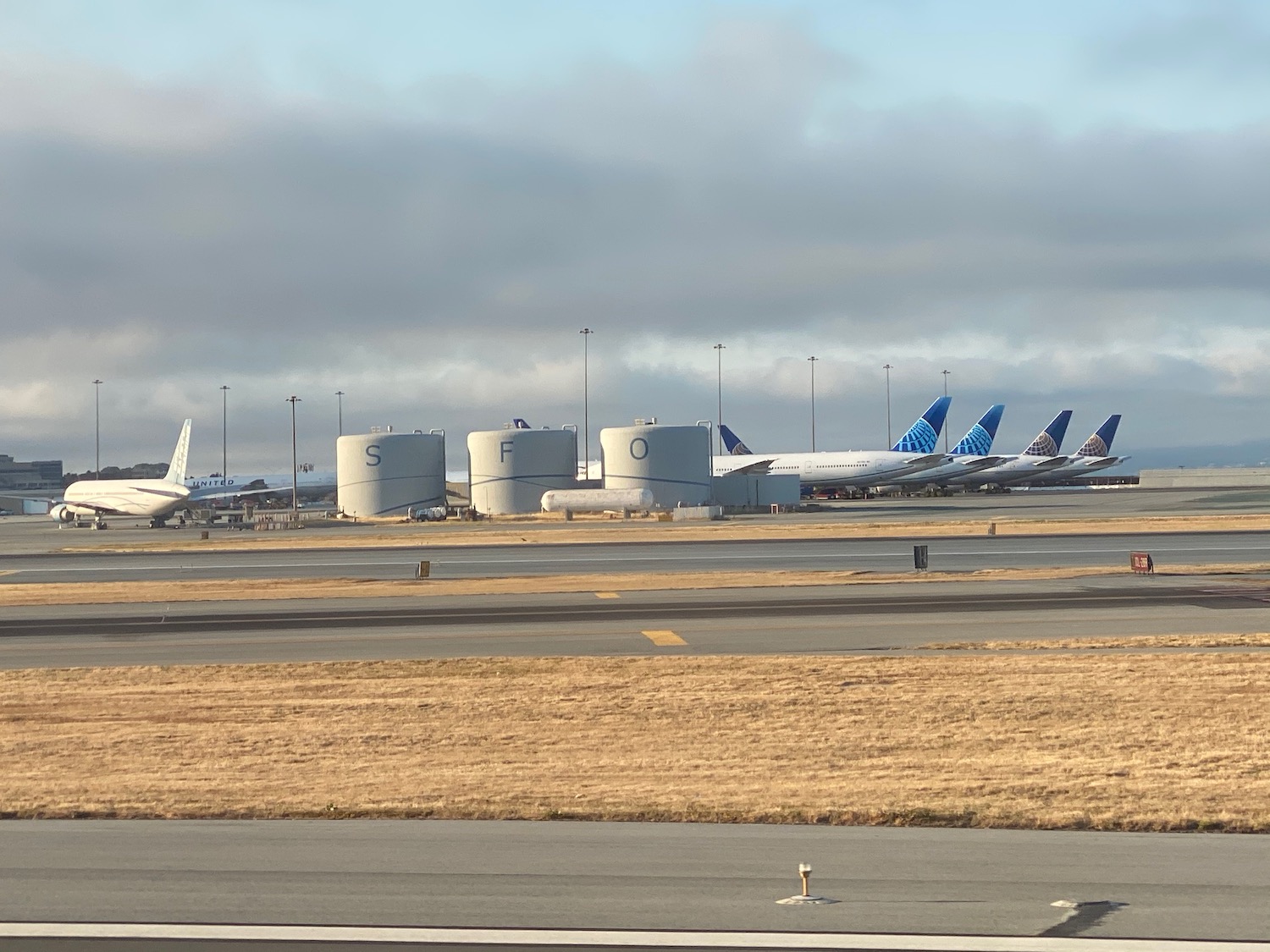 a group of airplanes parked at an airport