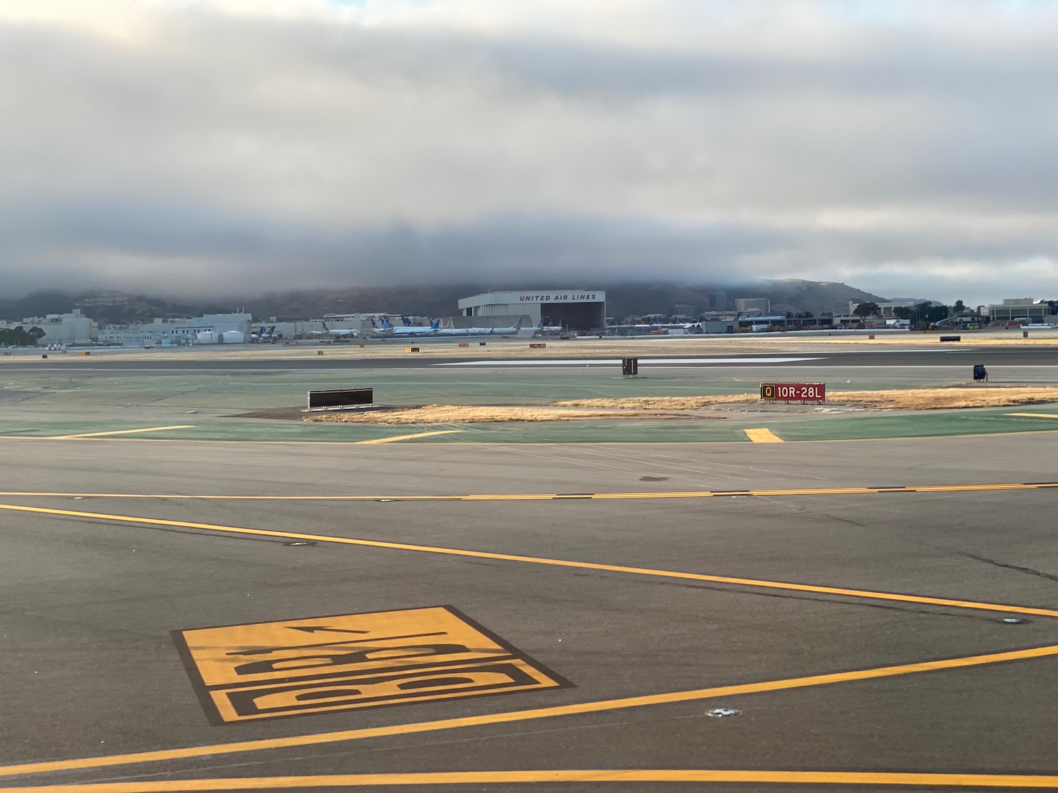 an airport runway with a large building in the background