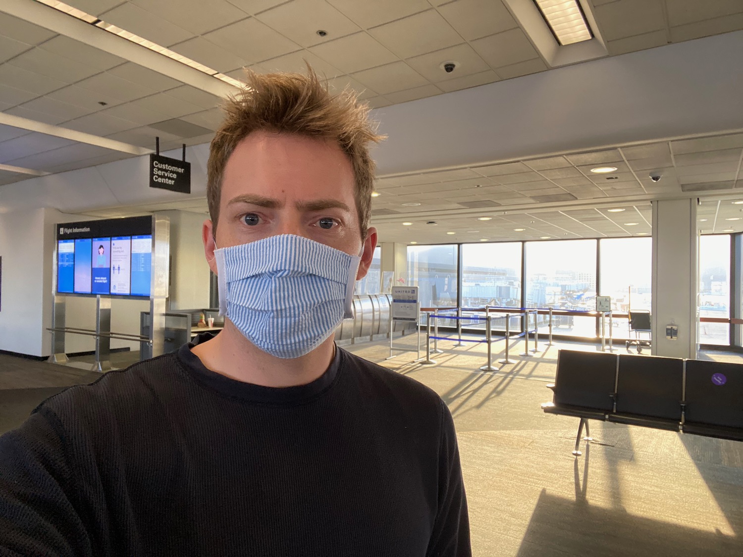 a man wearing a mask in an airport