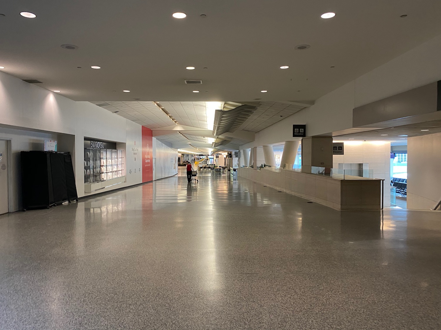 a large white building with a few people walking in it