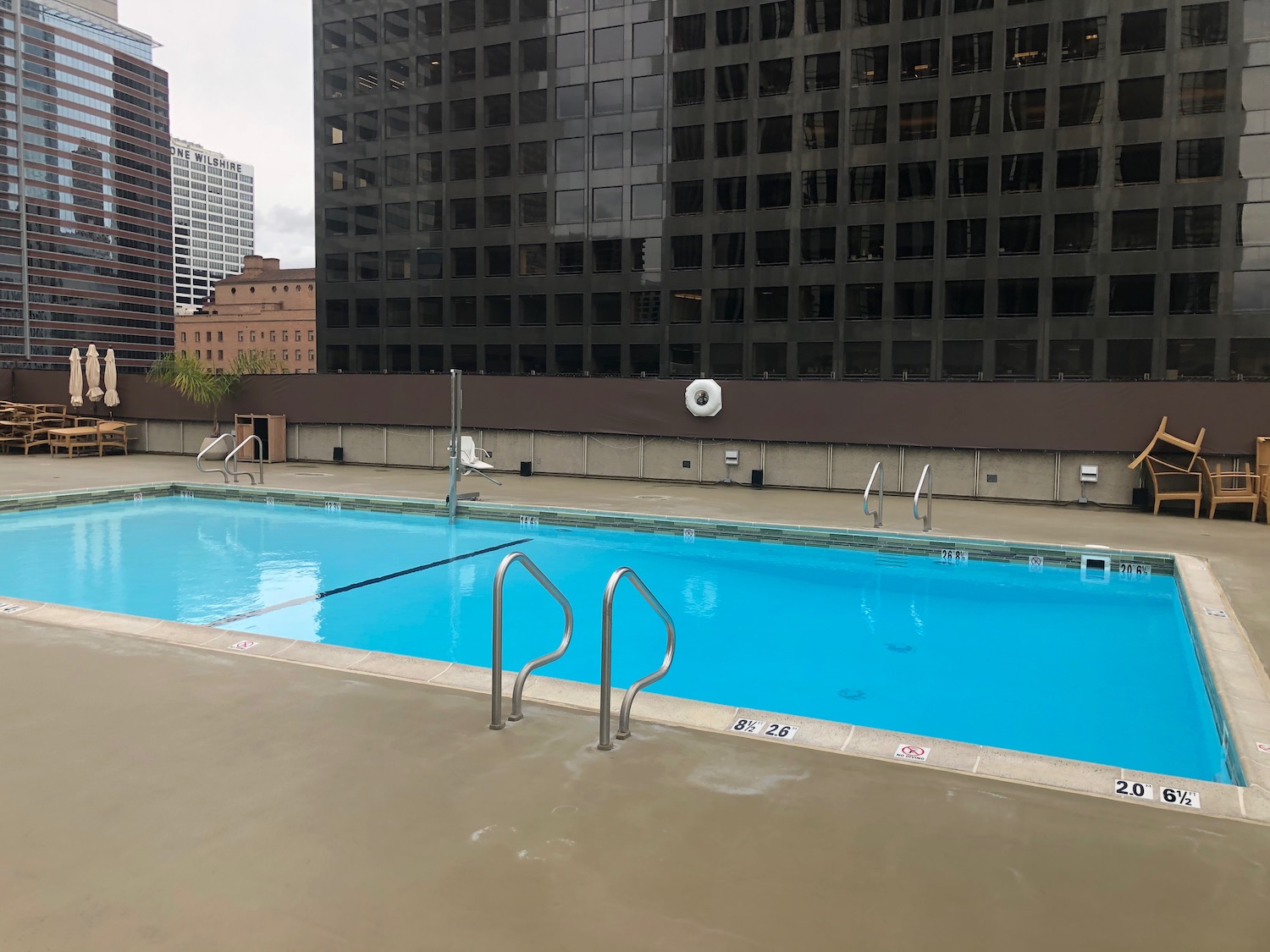 a swimming pool with a building in the background