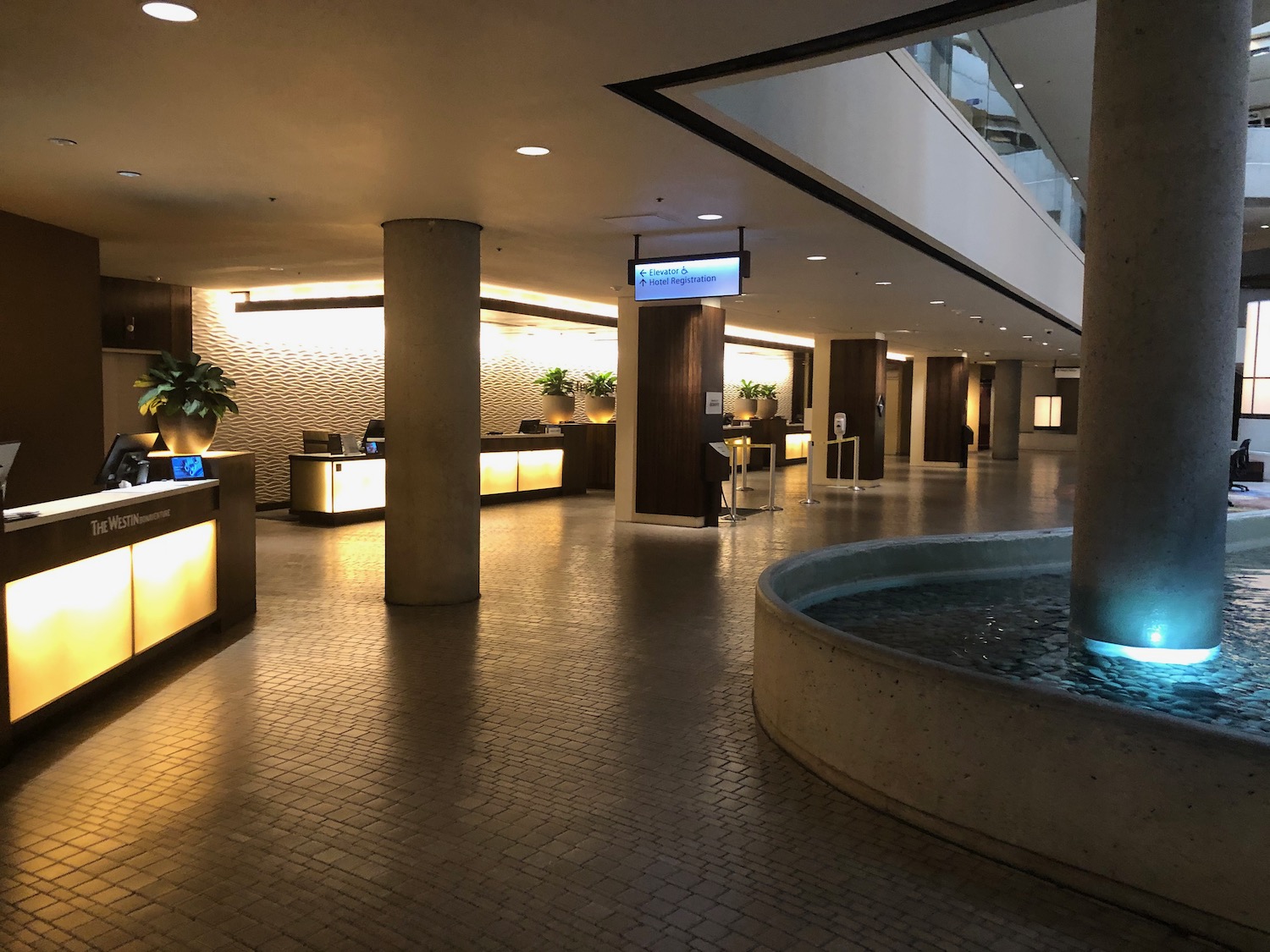 a large building with a fountain and a glass ceiling