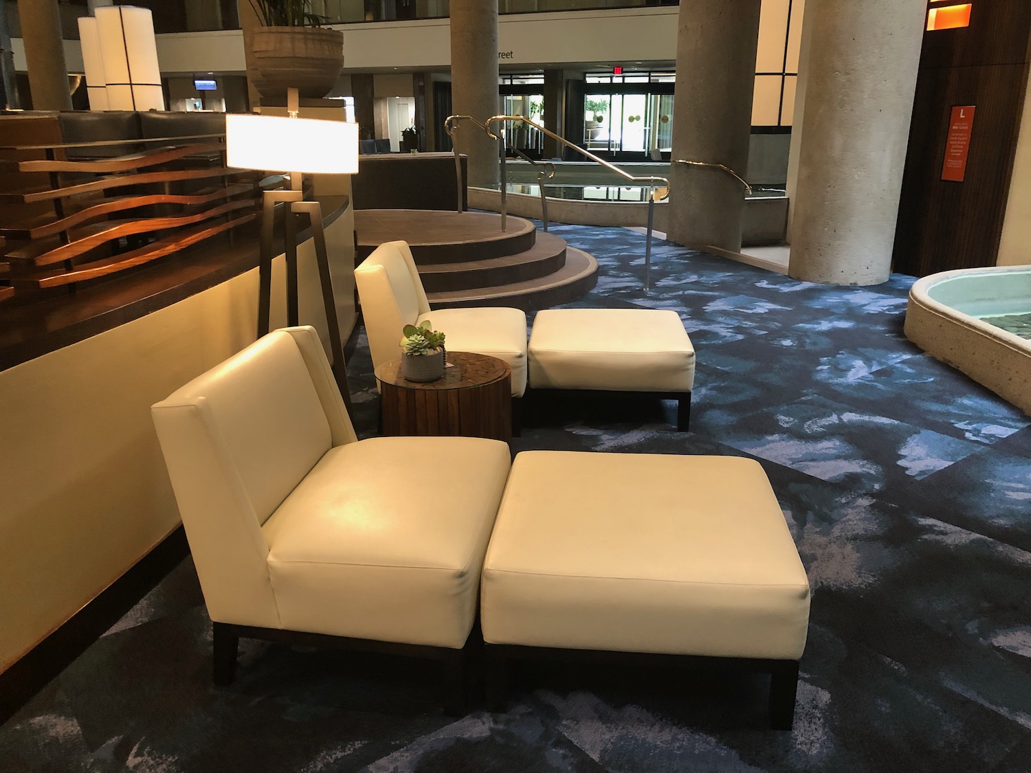 a group of white chairs in a lobby