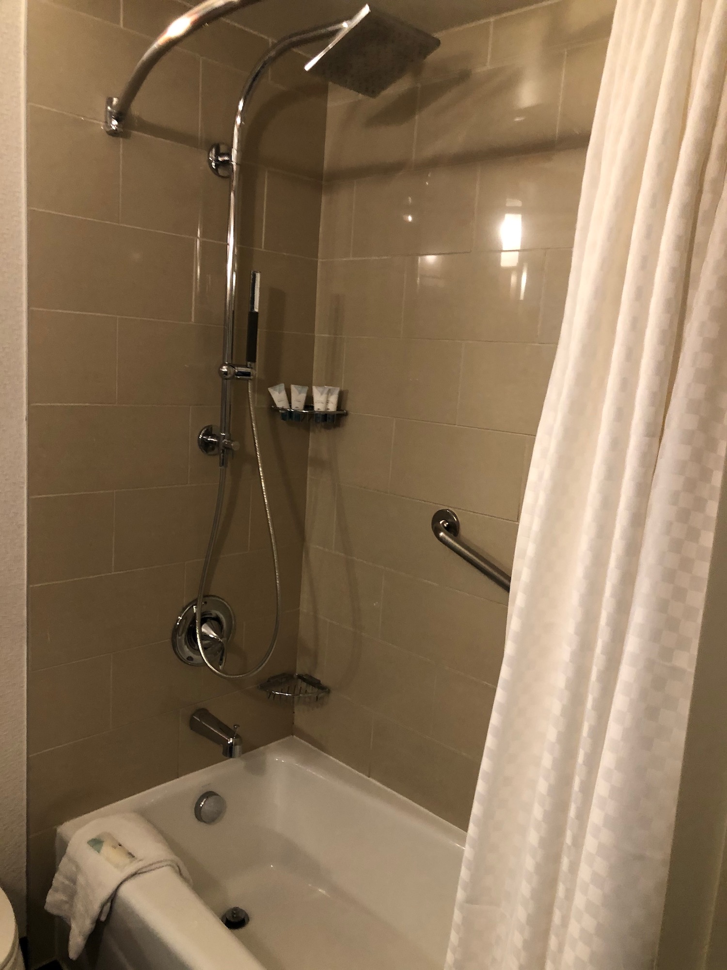 a shower with a shower head and a bathtub