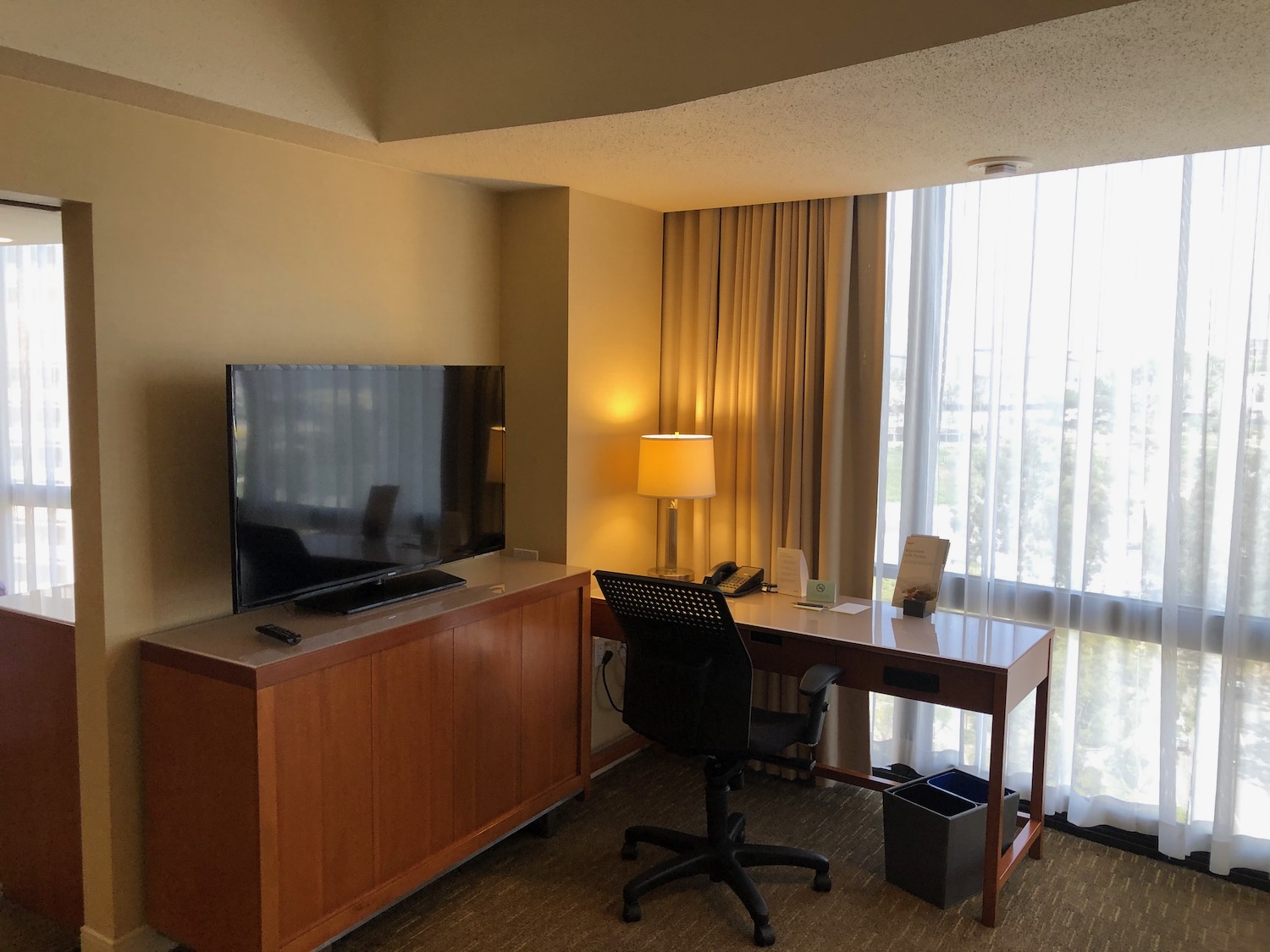 a room with a television and a desk