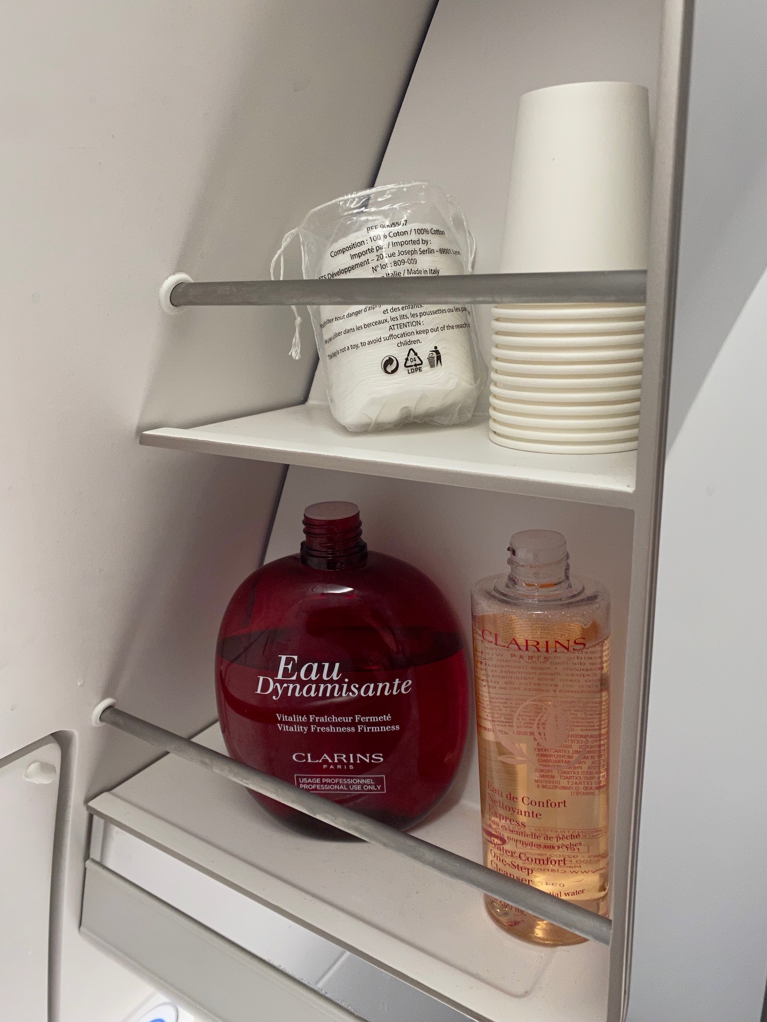 a shelf with bottles and cups on it