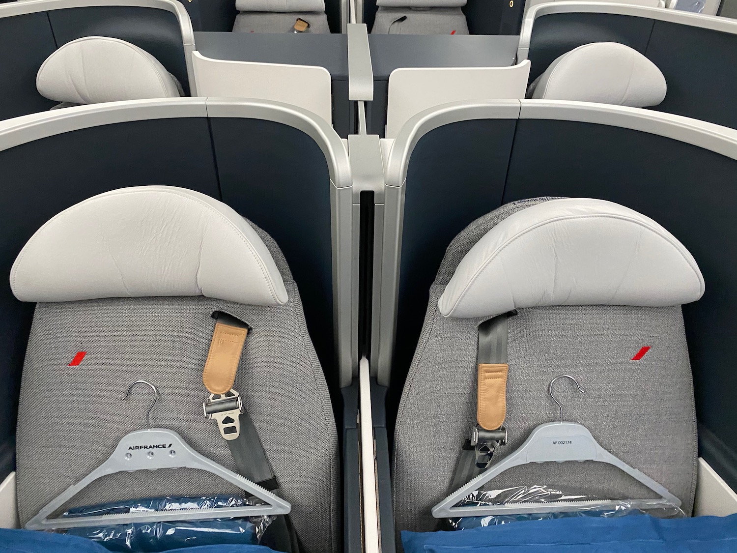 seats in an airplane with a swinger on the back