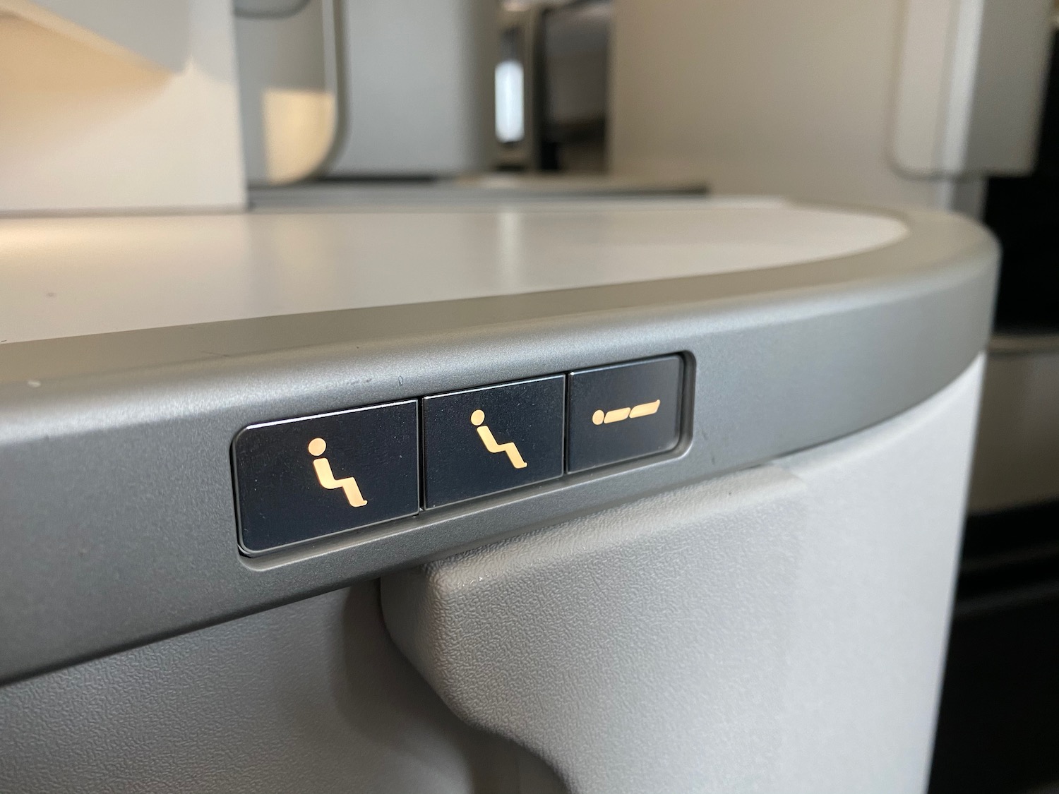 buttons on a seat in an airplane
