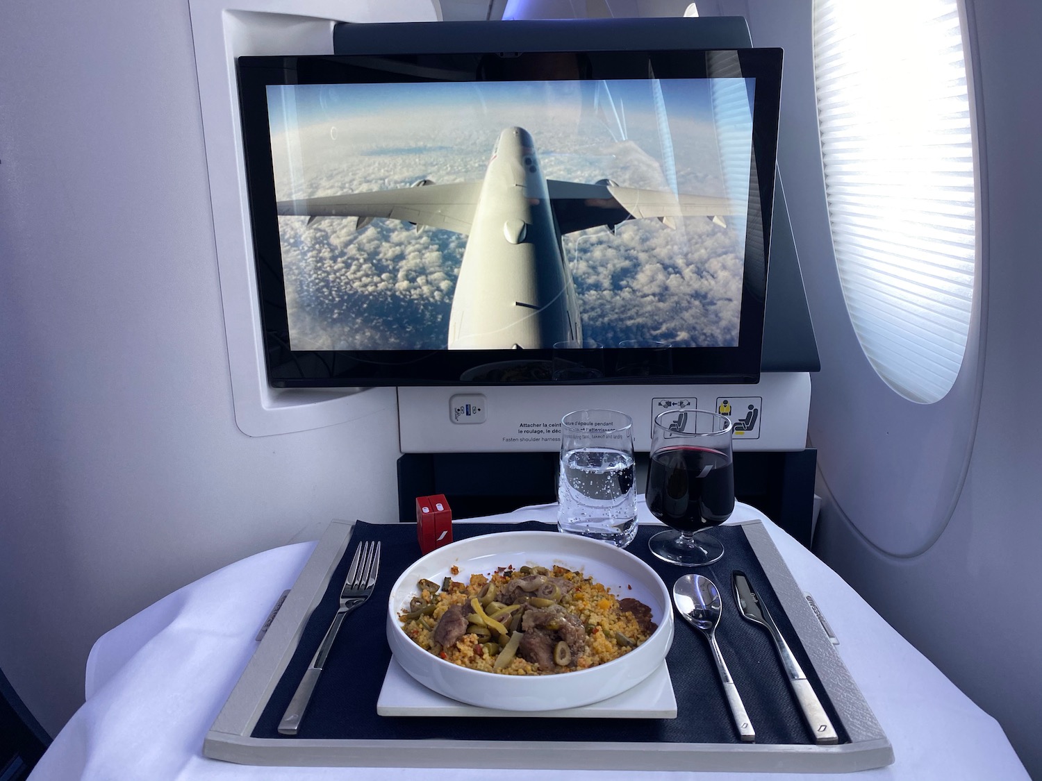 a plate of food on a tray with a television and a screen