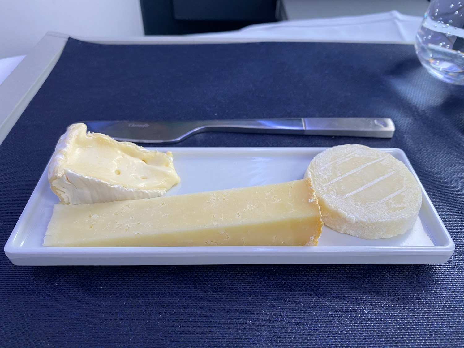 a plate of cheese and a knife