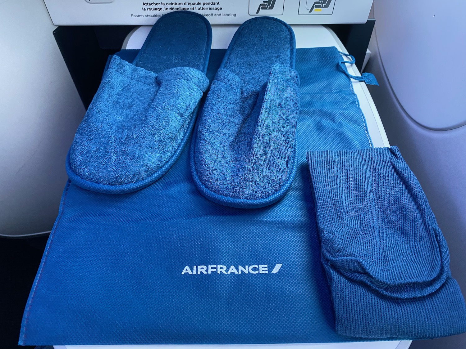 a pair of slippers and a blue towel on a blue mat