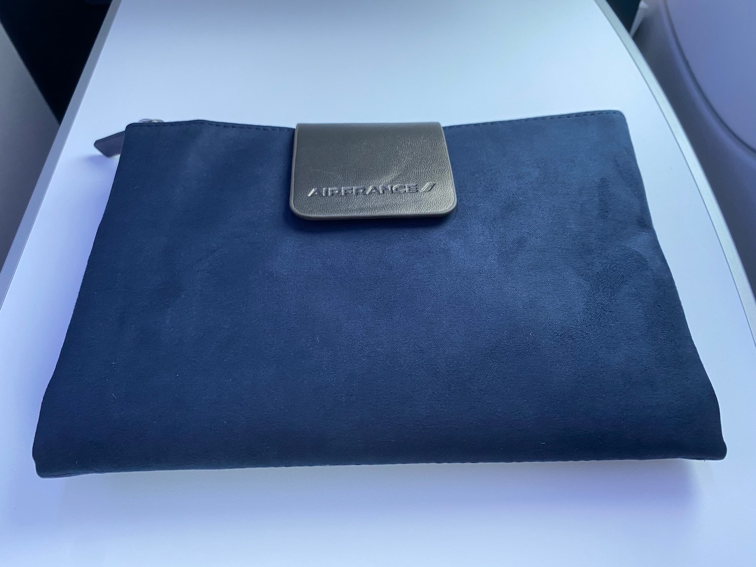 a blue bag on a white surface