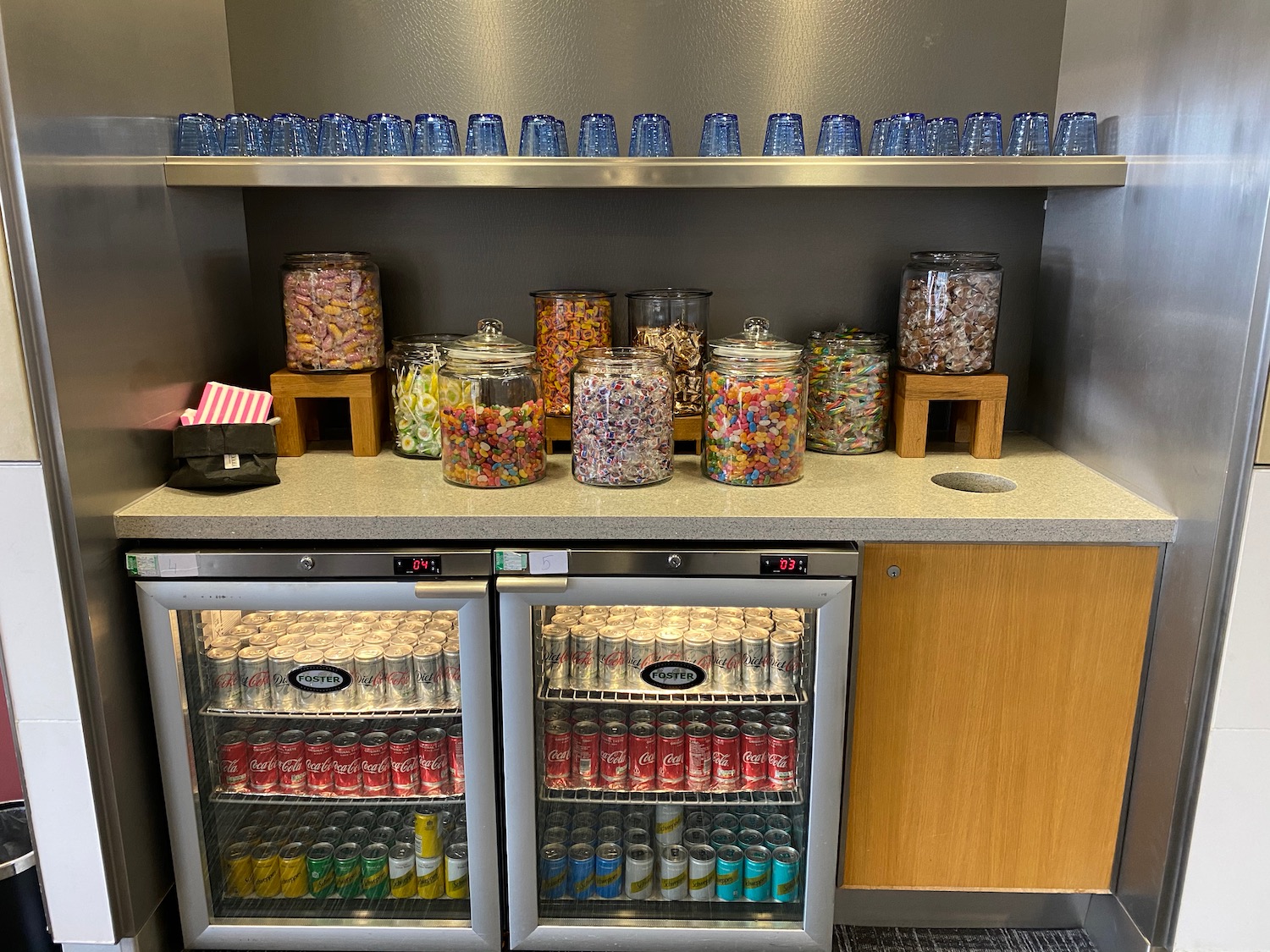 a fridge with a variety of candy and soda