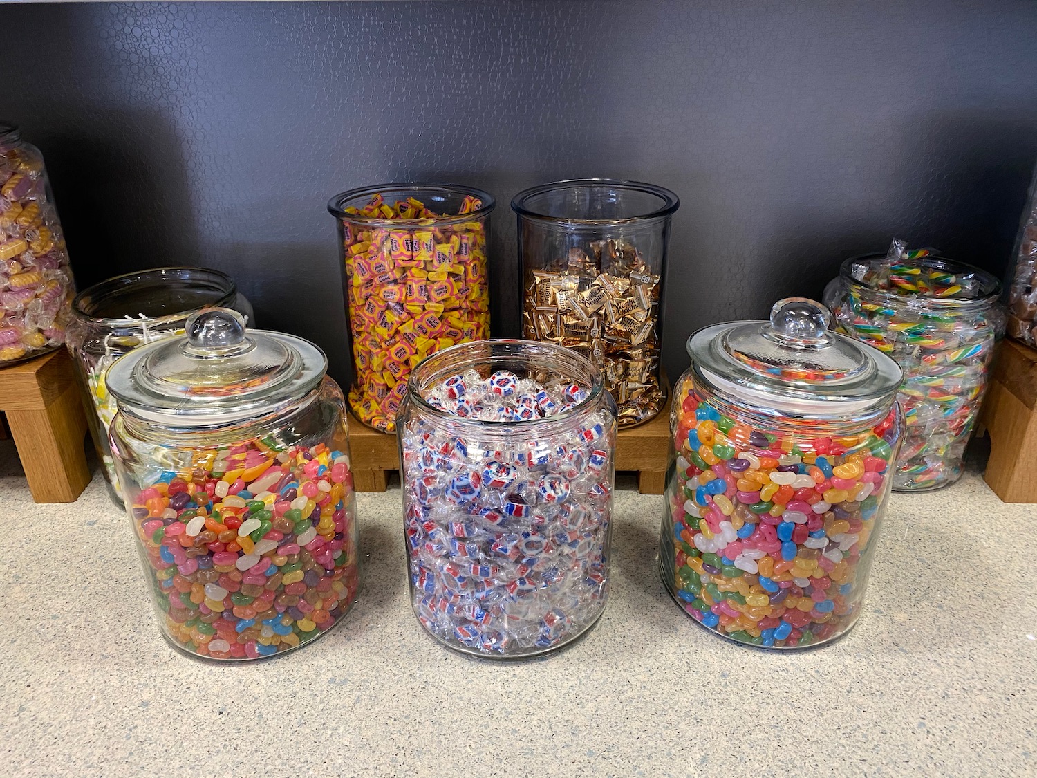 a group of glass jars filled with candy
