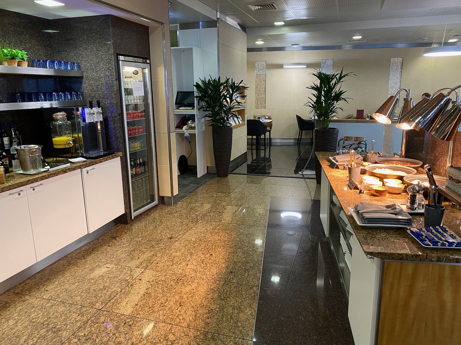 a kitchen with a buffet and plants