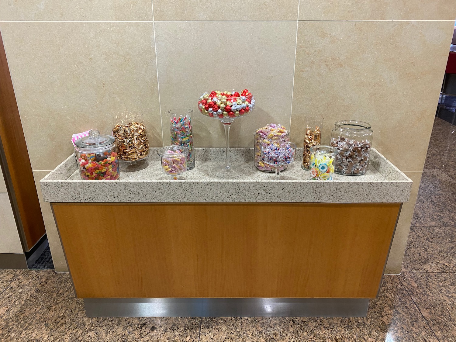 a counter with a group of candy in a glass bowl