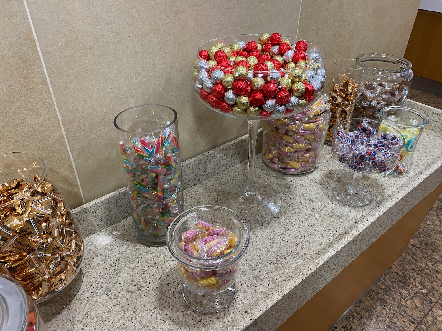 a group of glass containers filled with candy