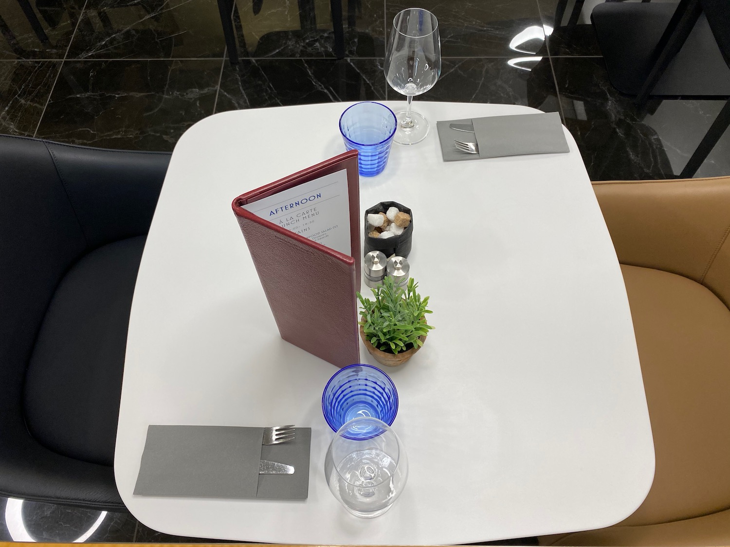 a table with a menu and glasses