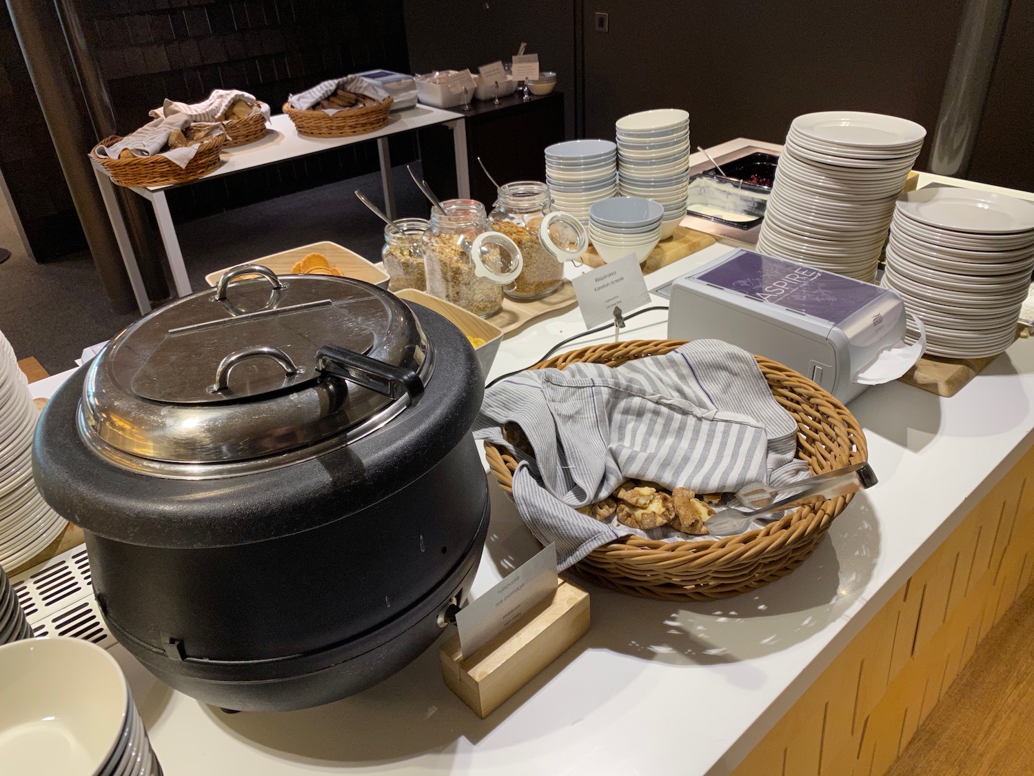 a table with plates and bowls and a black pot