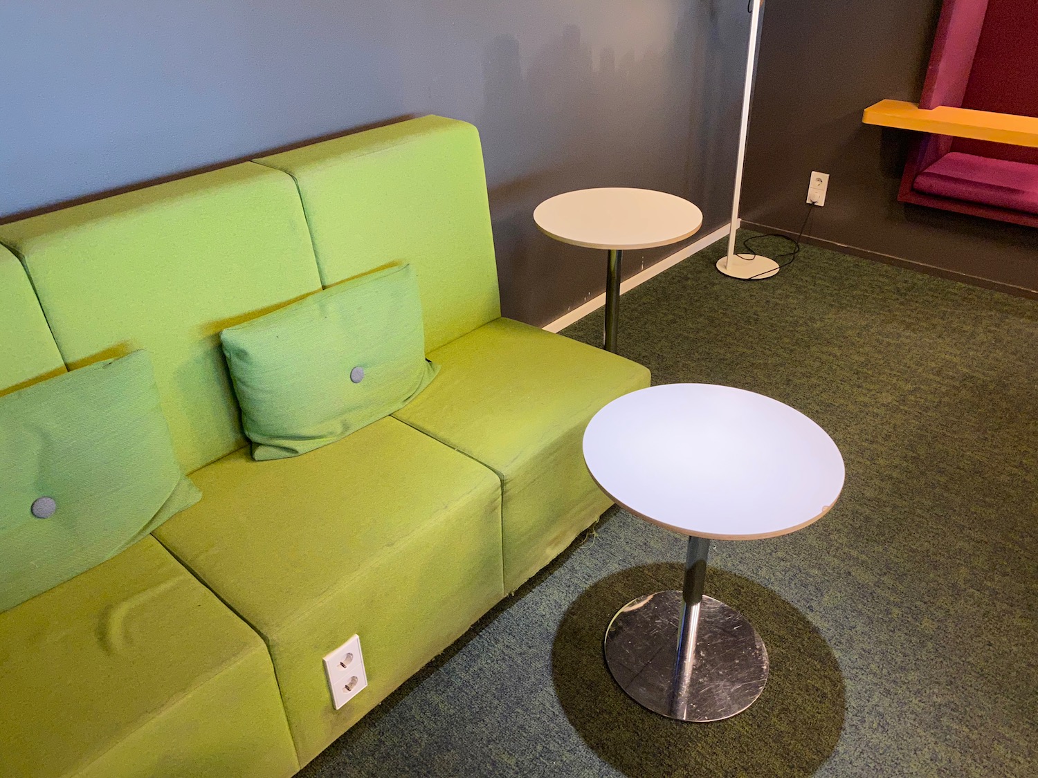 a green couch and white table in a room