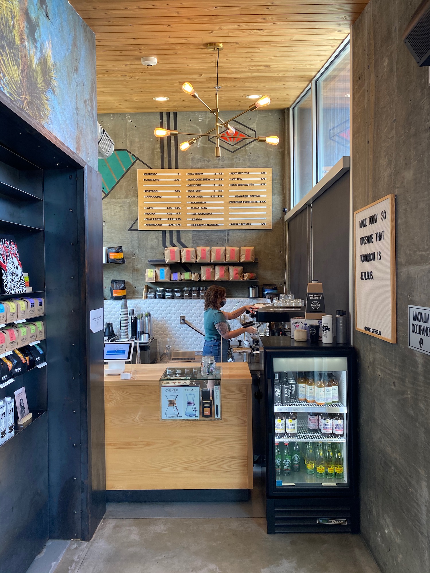 a woman behind a counter in a coffee shop