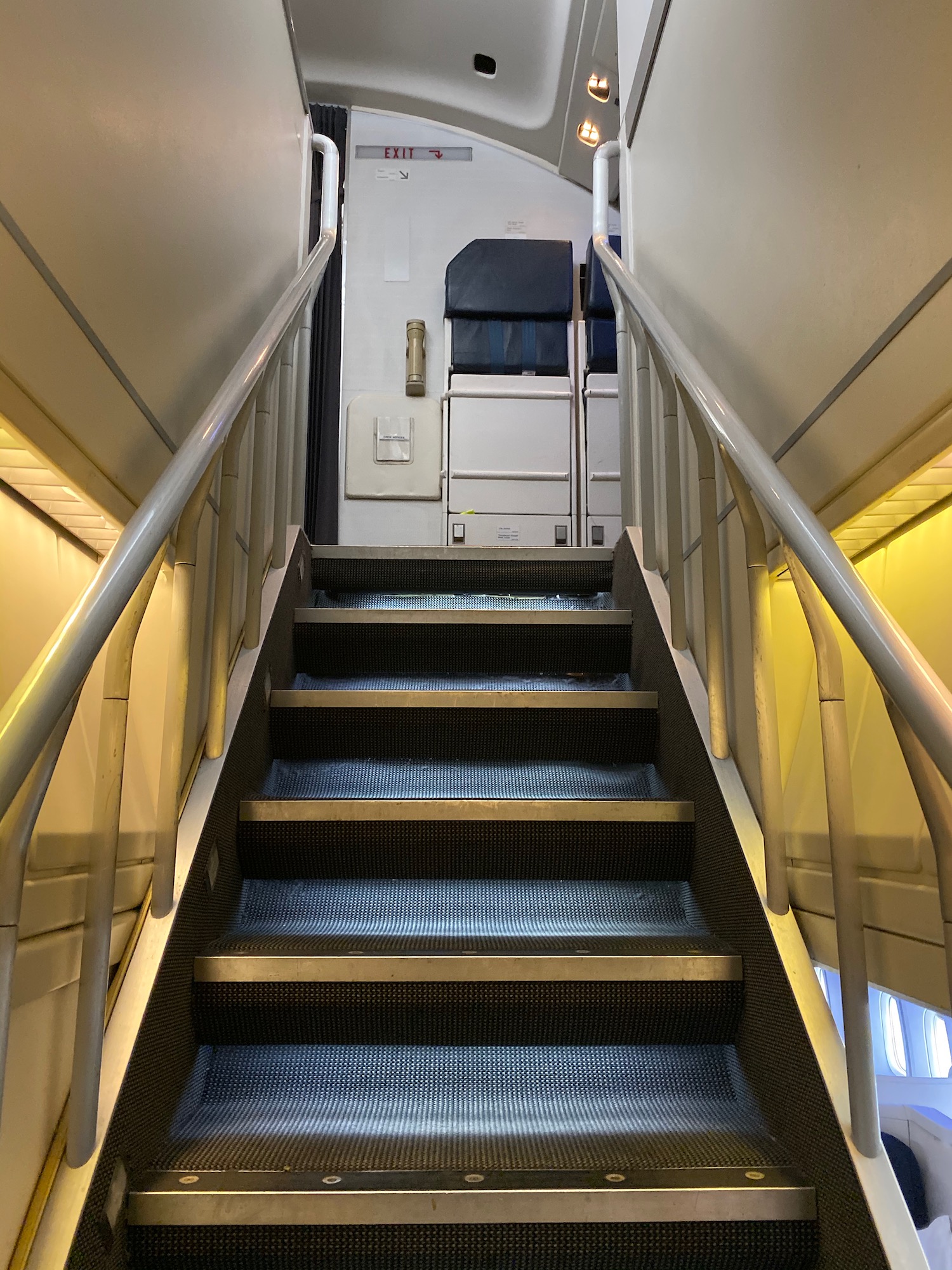 a staircase with metal railings and a door