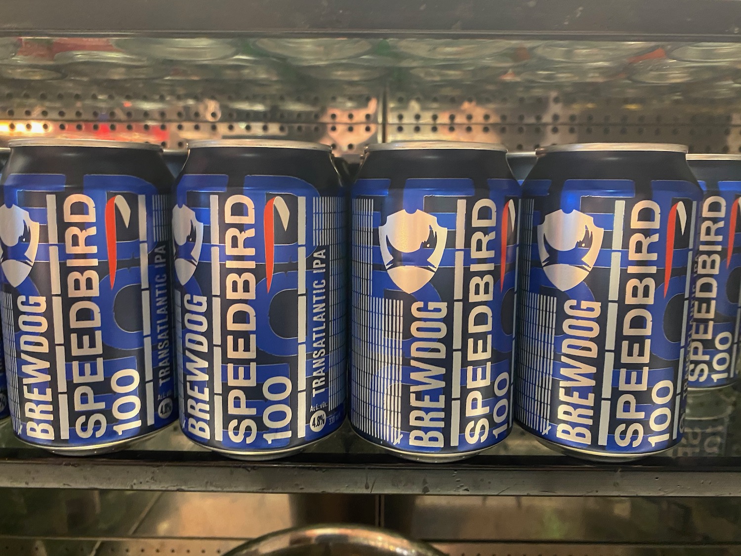 a group of blue and white cans on a shelf